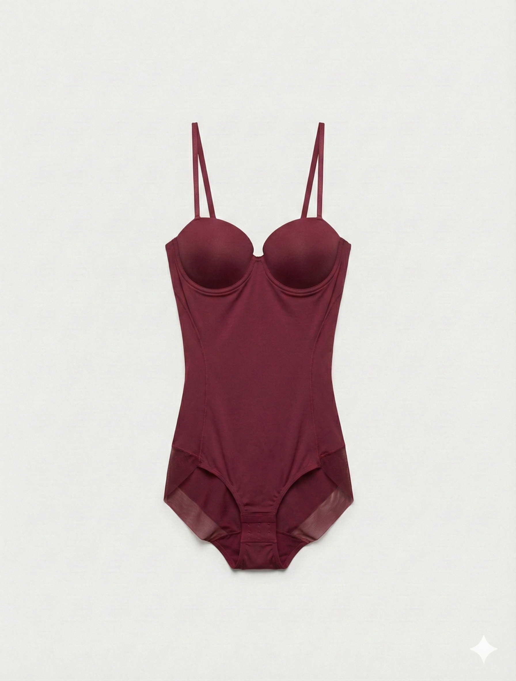 Maroon swimsuit with thin straps on a light gray background